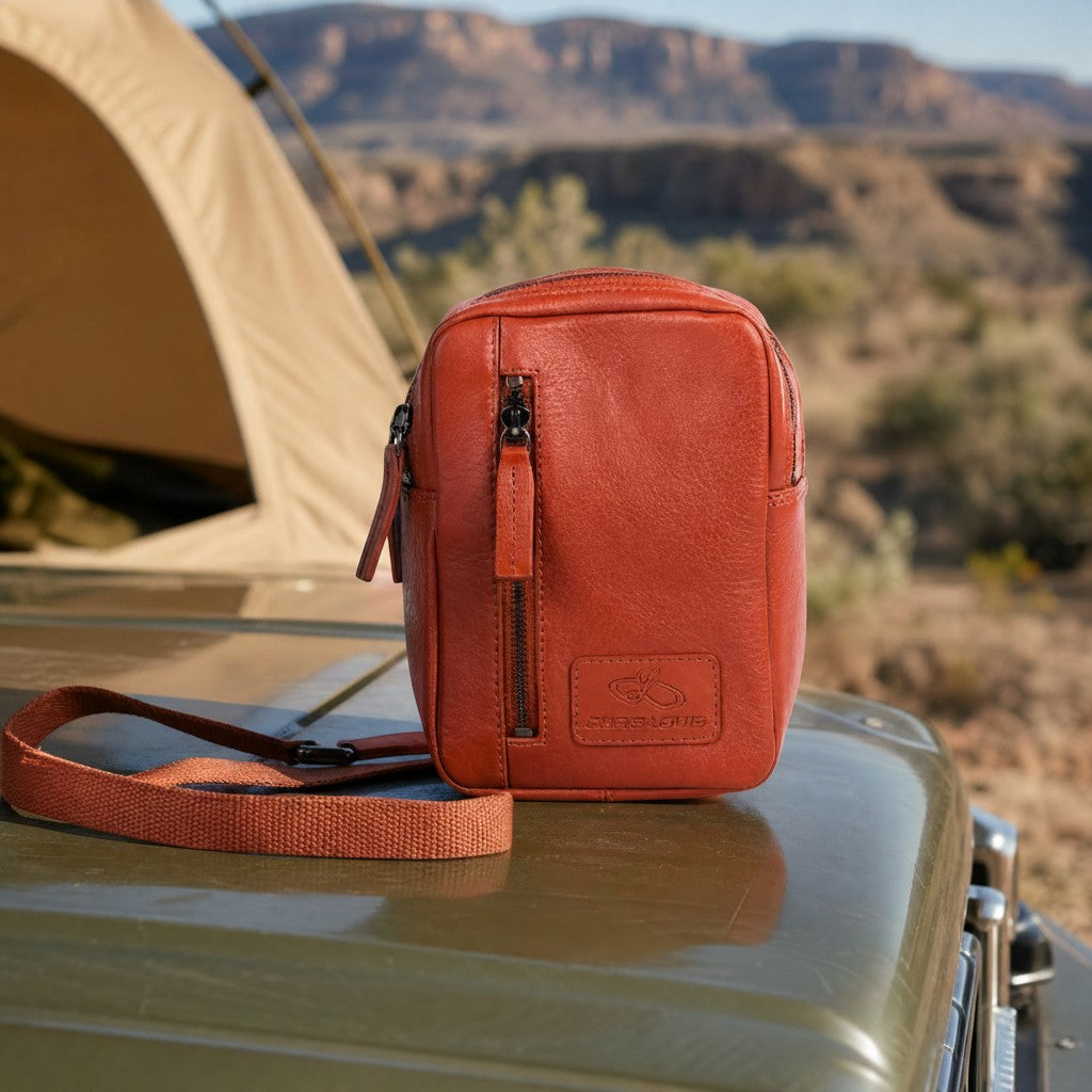 Chris Louis Aoraki cross-body travel bag in tan genuine leather with front zipper pocket and adjustable strap.