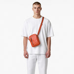 Chris Louis Aoraki cross-body bag in tan genuine leather with adjustable strap and front zipper pocket.