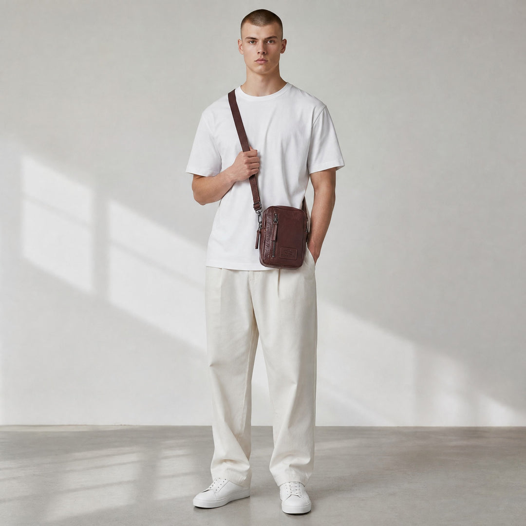 Chris Louis brown genuine leather cross-body travel bag with front zipper pocket and adjustable strap.