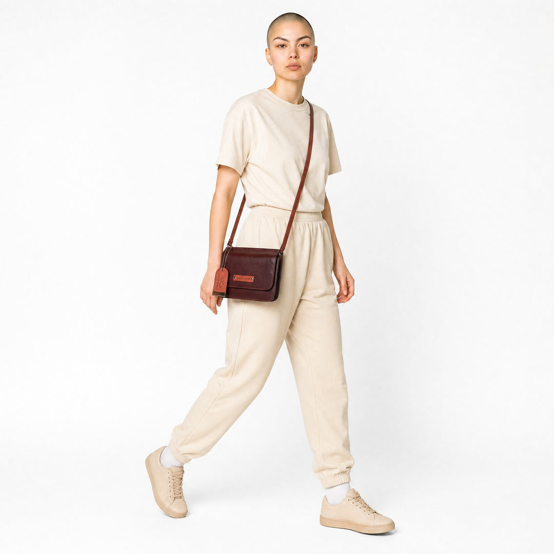 Chris Louis brown leather crossbody wallet with orange strap and trim, featuring a flap closure and embossed logo.