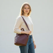 Chris Louis brown genuine leather hexagon shoulder bag with adjustable straps and front zipper pocket.