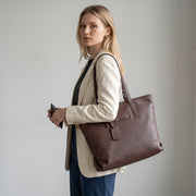 Chris Louis Ceren brown leather tote bag with top handles and metal hardware. Features a main zipper compartment and interior pockets.