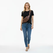 Chris Louis brown leather unisex bum bag worn across the body by a woman in a black t-shirt and jeans.