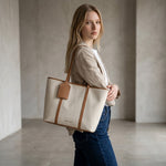 Chris Louis Diana Large Tote Bag in cream canvas with tan polyurethane trim and handles. Features a hanging luggage tag and magnetic closure.