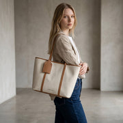 Chris Louis Diana Large Tote Bag in cream canvas with tan polyurethane trim and handles. Features a hanging luggage tag and magnetic closure.