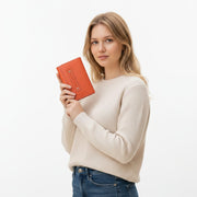 Chris Louis Gilgie ladies tri-fold wallet in orange genuine leather with snap closure and multiple card slots.