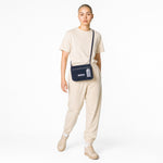 Chris Louis Isfahan Crossbody Bag in deep navy leather with light grey stitching and strap. Features flap closure and metal logo.