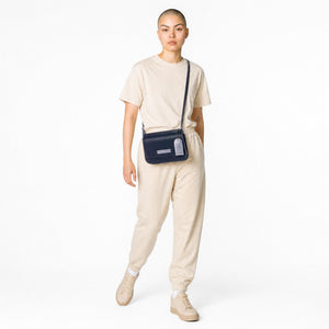 Chris Louis Isfahan Crossbody Bag in deep navy leather with light grey stitching and strap. Features flap closure and metal logo.