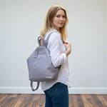 Chris Louis Jarrah grey genuine leather hexagon backpack with adjustable straps and front zipper pocket.