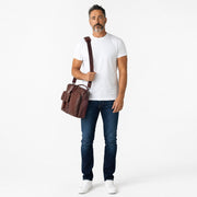 Chris Louis genuine leather briefcase messenger bag in chestnut brown with buckle flap pocket and zippered pocket.