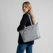 Chris Louis light grey pebbled leather tote bag with zip-top closure and adjustable straps.