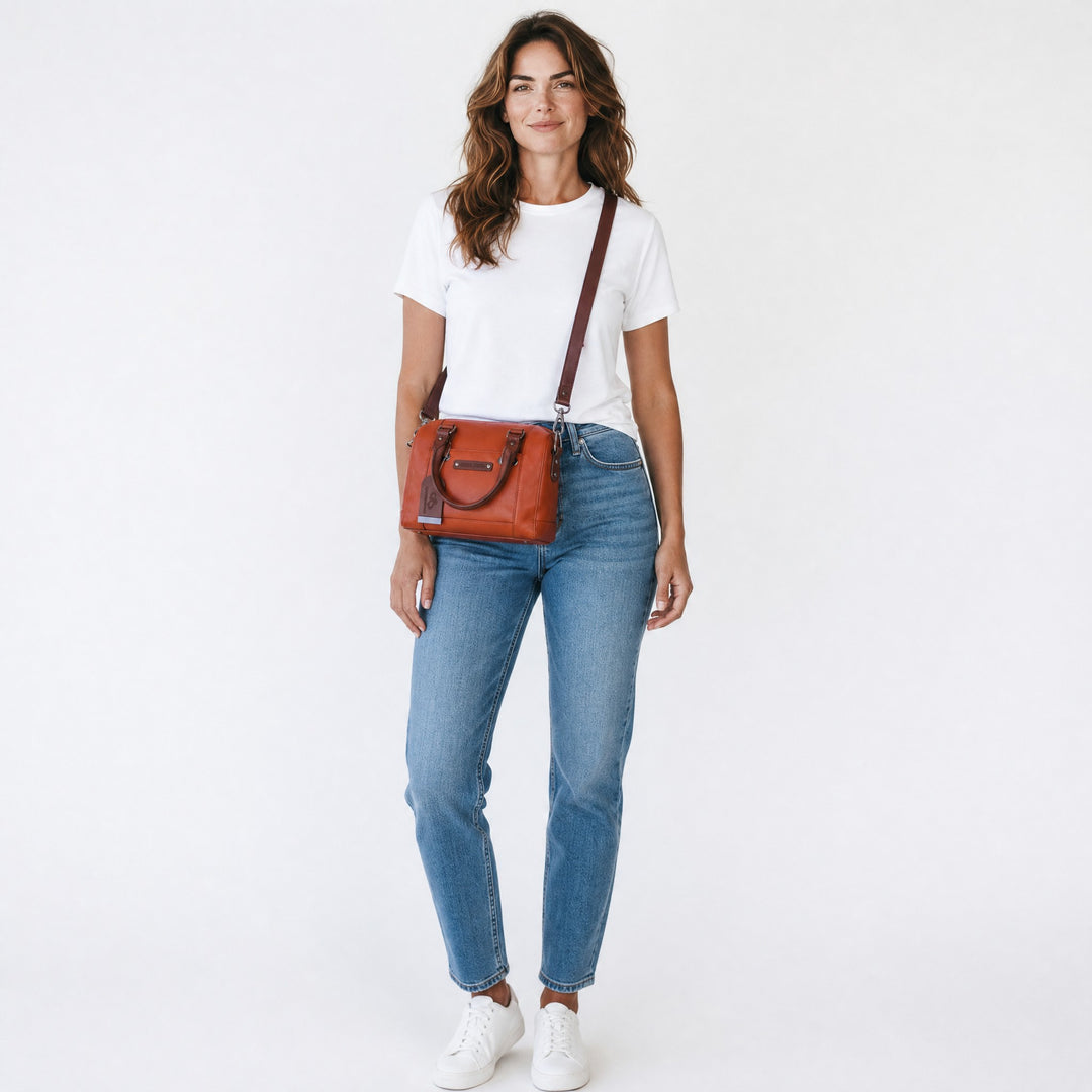 Chris Louis Leone Petite Satchel Bag in warm tan genuine leather with dark brown handles and strap. Features zip-top closure.