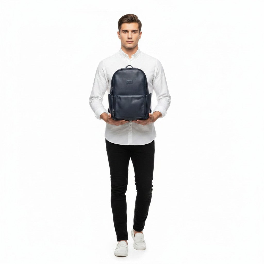 Chris Louis navy blue leather unisex backpack with adjustable padded straps and exterior pockets, carried by a woman.