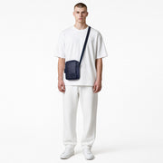 Chris Louis navy blue genuine leather cross-body travel bag with adjustable strap and front zipper pocket.
