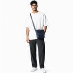 Chris Louis navy blue genuine leather crossbody bag with double roller buckle closure and adjustable strap.