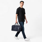 Chris Louis navy genuine leather duffle bag with luggage tag and stitched detailing. Ideal for weekend travel.