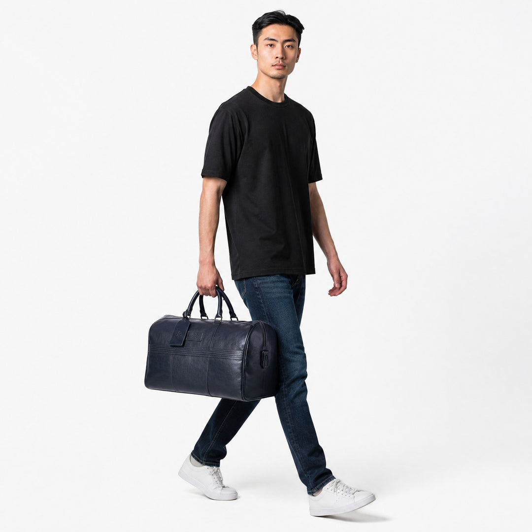 Chris Louis navy genuine leather duffle bag with luggage tag and stitched detailing. Ideal for weekend travel.