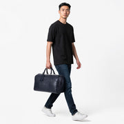 Chris Louis navy genuine leather duffle bag with luggage tag and stitched detailing. Ideal for weekend travel.