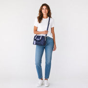 Chris Louis navy blue leather satchel handbag with light grey handles and adjustable strap, featuring a structured base and polished hardware.