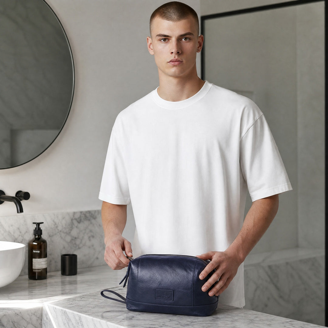 Chris Louis navy blue genuine leather toiletry bag with wrist strap and multiple compartments.