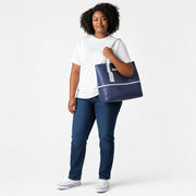 Chris Louis navy blue leather tote bag with light grey handles and white horizontal piping detail.