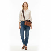 Chris Louis Olyia tan/brown full grain leather unisex pouch bag with multiple zipper compartments.