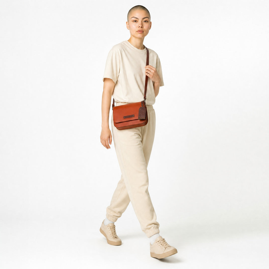 Chris Louis Isfahan crossbody bag in vibrant orange genuine leather with adjustable strap and embossed logo tag.