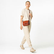 Chris Louis Isfahan crossbody bag in vibrant orange genuine leather with adjustable strap and embossed logo tag.