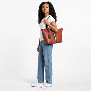 Chris Louis orange leather tote bag with black, grey, and white vertical stripe detail and brown straps.