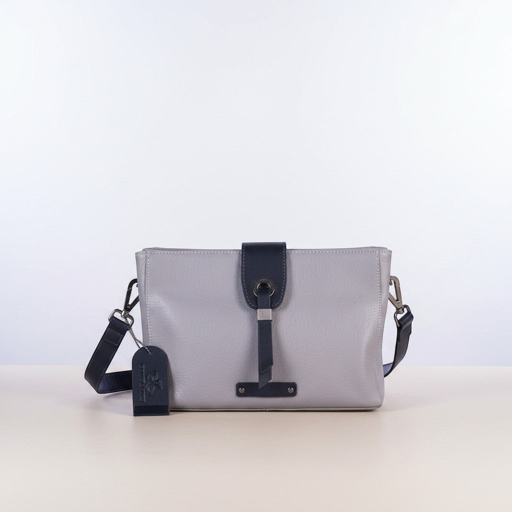 Chris Louis Santorini leather crossbody bag in light purple with dark navy accents and adjustable strap.