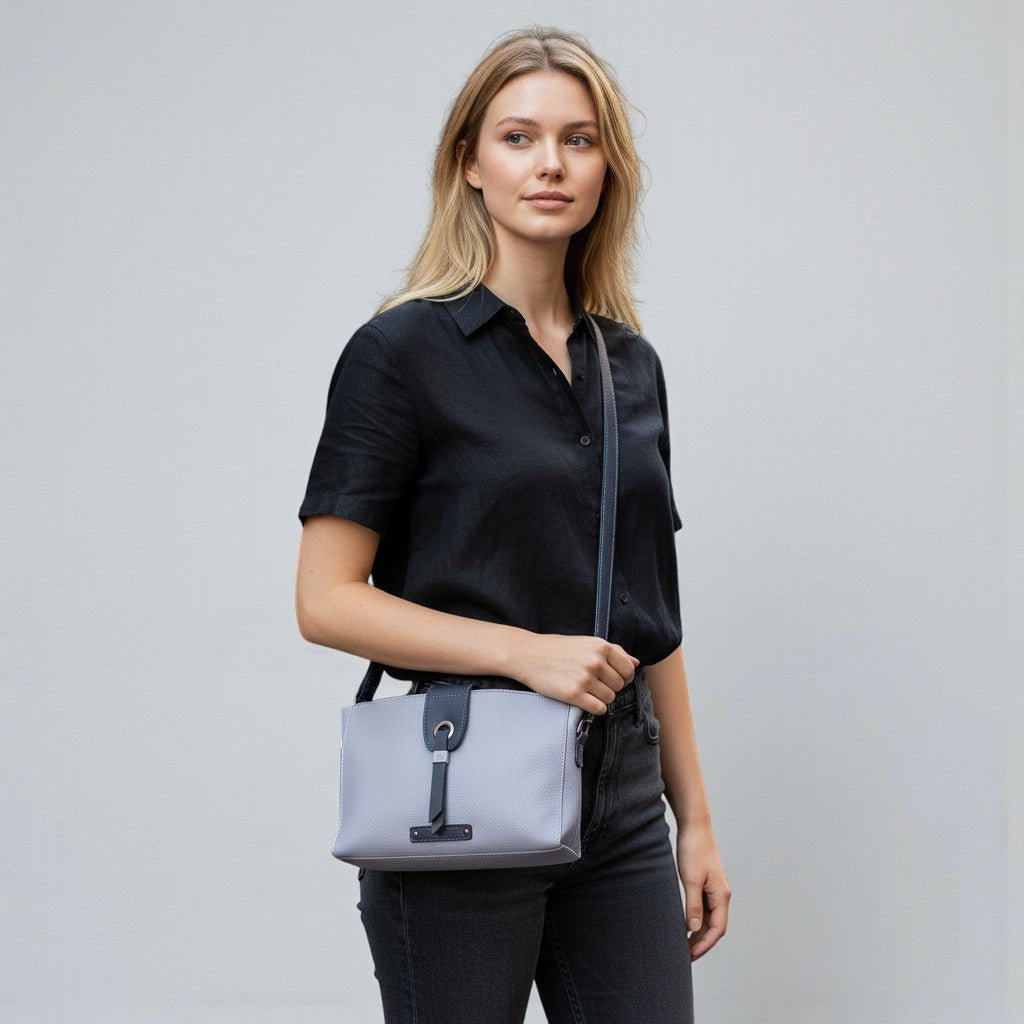 Chris Louis Santorini Leather Crossbody Bag in light purple with dark navy accents, adjustable strap, and secure closure.