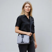 Chris Louis Santorini Leather Crossbody Bag in light purple with dark navy accents, adjustable strap, and secure closure.