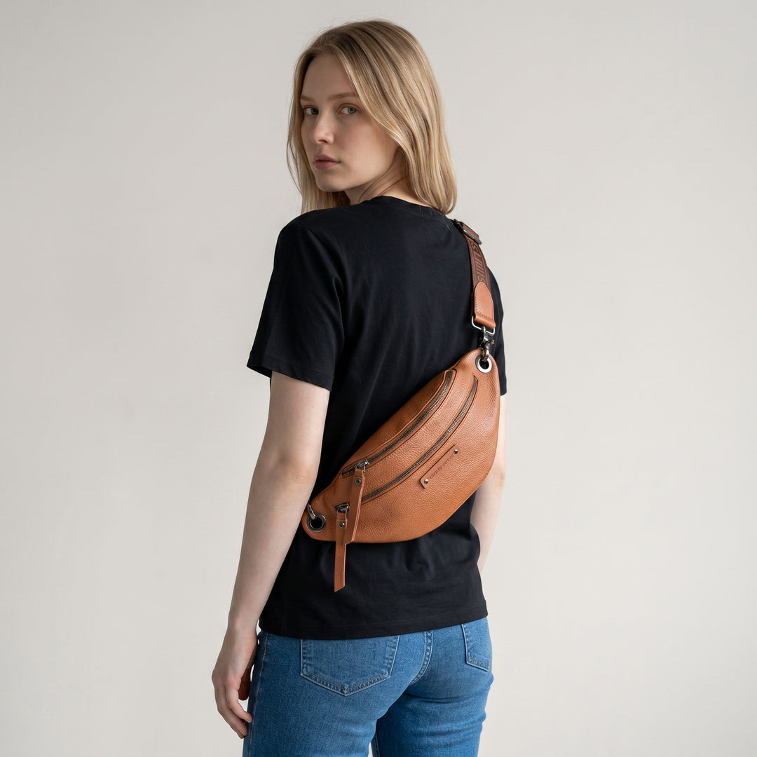 Chris Louis tan leather unisex bum bag with multiple zipper compartments and adjustable strap.