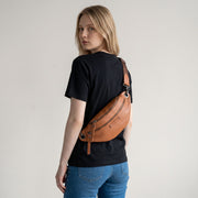 Chris Louis tan leather unisex bum bag with multiple zipper compartments and adjustable strap.