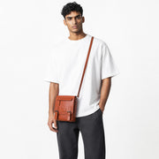 Chris Louis tan genuine leather cross body travel bag with double roller buckle closure and adjustable strap.