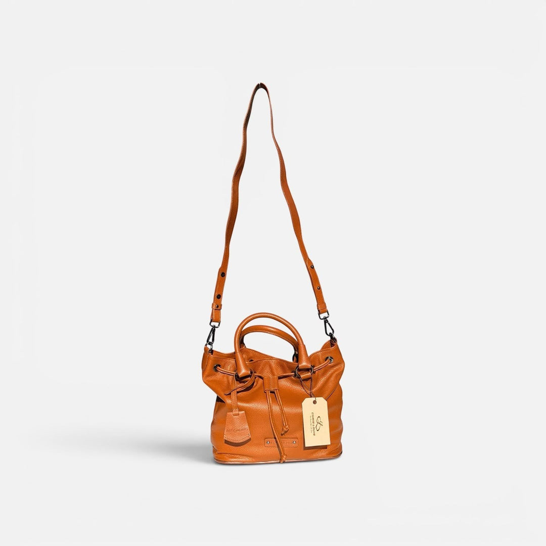 Chris Louis tan full grain leather satchel bag with drawstring, top handle, and adjustable crossbody strap.
