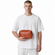 Chris Louis tan leather toiletry bag with zipper closure and interior pockets. Compact yet roomy for travel essentials.