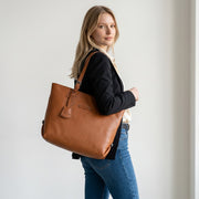 Chris Louis classic tan leather tote bag with shoulder straps and exterior zip pocket.